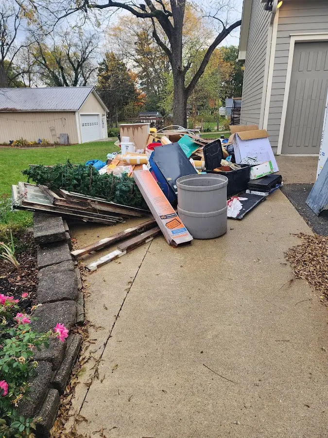 Dumpster being loaded with debris for Estate Cleanout Dumpster Rental in State College